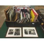 A box of music books relating to Bob Dylan etc and a framed black & white photographs and news