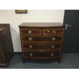 A bowfronted four drawer inlaid mahogany chest