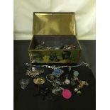 A vintage tin containing costume jewellery, cufflink, earrings etc.