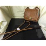 A quality hide stitched bag, together with three walking sticks.