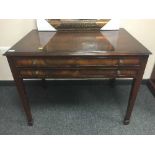 A mahogany two drawer canteen table fitted with silver plated cutlery.