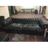 A green leather Chesterfield four seater settee