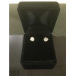 A pair of diamond stud earrings set in 18ct white gold, each approximately 0.75ct.