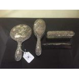 A sterling silver Art Nouveau style four piece dressing table set.