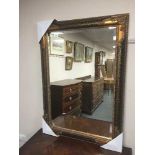 A distressed black framed mirror