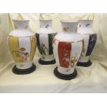 A set of four Chinese vases on wooden plinths