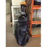 A Hippo golf bag and a set of Taylor Made irons,