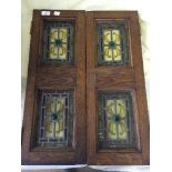 Two oak panelled stained glass windows and a framed mirror