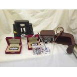 A tray of pair of Dienstglas binoculars, glass desk stand, two boxed Kinotel microscope lens,