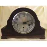 An oak cased mantel clock