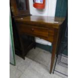 A Singer electric sewing machine within mahogany table.