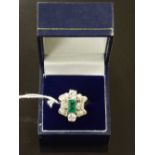 An 18ct white gold emerald and diamond ring