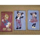 Three hand painted tin Disney plaques