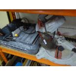 A tile cutter together with a Black and Decker hammer drill and a Performance saw