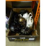 A box containing a Victorian lustre teapot, hand painted teapots on stands,