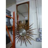 A teak battery operated Sef Thomas Sunburst clock together with a 1970's teak framed mirror.