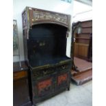 An Oriental lacquered and gilt cabinet.