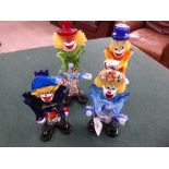 Four Murano glass clowns.