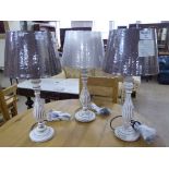 A set of three wooden contemporary table lamps with shades