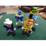 Four Murano glass clowns.