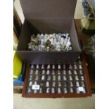 A box and two display cases containing a large quantity of china and pewter thimbles.