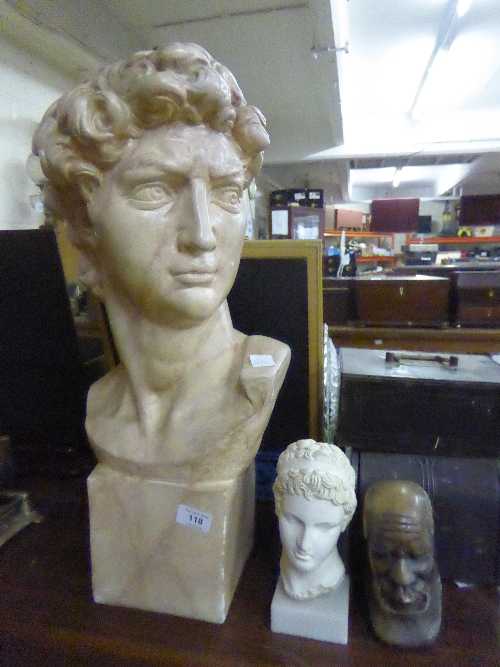 A chalk bust of David together with one other and a small marble bust of an African gentleman.