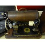 A vintage Singer sewing machine in oak case