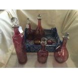 Crate of seven assorted ruby glass decanters