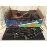 A box of assorted tin plate track and rolling stock,