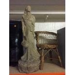 A resin sculpture of a flower maiden signed Alice Heath and a child's wicker chair