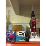 A Hoover Smart vac, a cylinder vac, assorted irons,