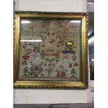 A gilt framed continental sampler dated 1876