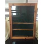 A pine wall mounted display cabinet and mirrored bathroom cabinet