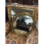 An oval gilt framed mirror and one other