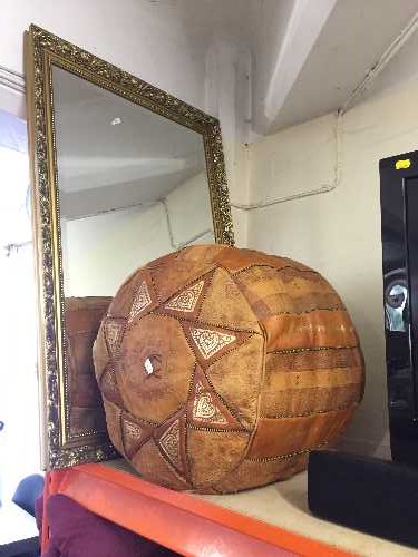 A Moroccan style leather footstool and a gilt framed mirror