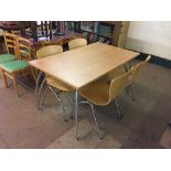 A beech effect kitchen table on chrome legs with four Nowy style chairs