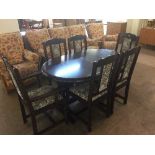A reproduction oval oak extending table and six tapestry chairs