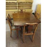 A mahogany extending dining table and four chairs