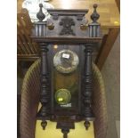 An Edwardian wall clock with pendulum