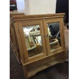 A pine double mirror doored wall cabinet