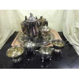 A large quantity of plated tea ware and a brass embossed tray