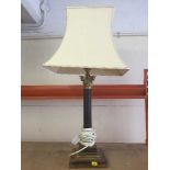 A brass Corinthian column table lamp with shade