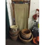 A mid 20 th century deck chair and a quantity of terracotta plant pots