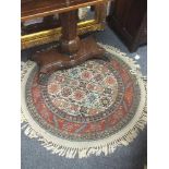 A circular fringed Persian rug with silk highlights