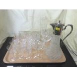 A tray of assorted crystal drinking glasses and a large blue glass fruit bowl