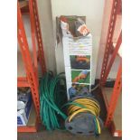 A Flymo strimmer and two hose pipes (one on reel)