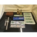 A box of sterling silver napkin ring, Casio watch, harmonicas, US 2 dollar bills,
