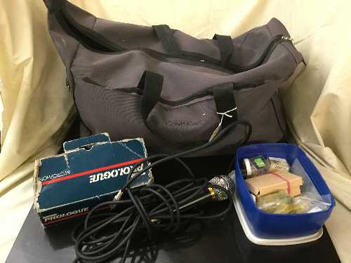 A Calvin Klein holdall of assorted cables, microphones, fuses,