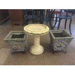 A pair of stone garden planters and a garden bird bath