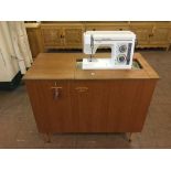 A Toyota electric sewing machine in teak cabinet